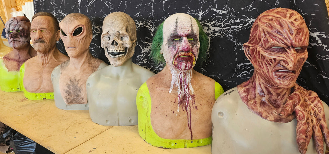 Bench in Mr E Mask workshop showing six handmade silicone masks
