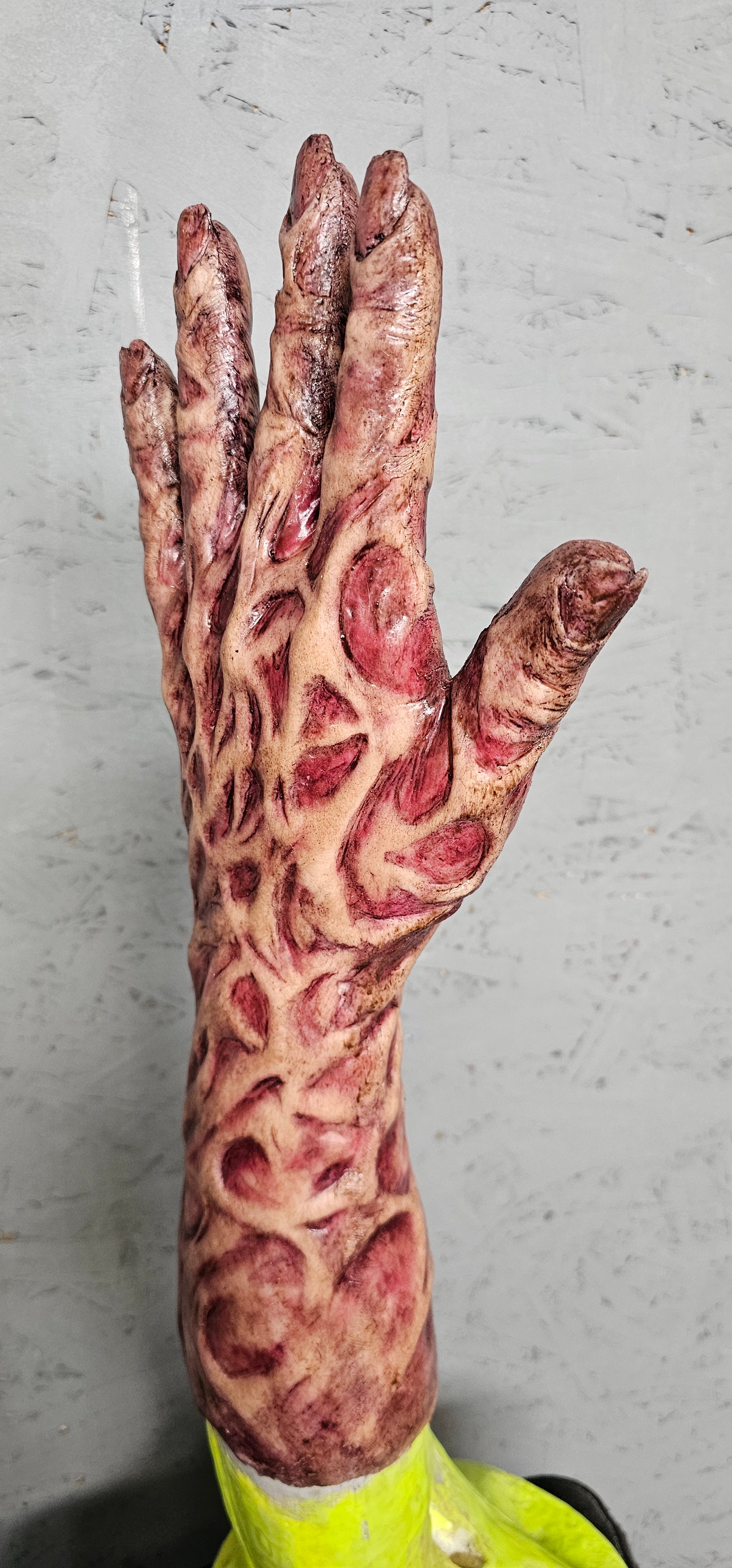 Realistic burnt silicone hand sleeve close-up detail