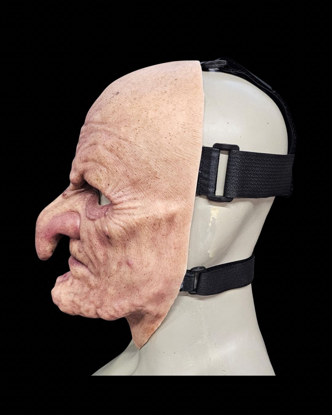Old Hag silicone witch mask, left-side view showing the straps
