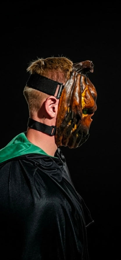 Side view of the Jack O’ Lantern pumpkin mask showing its adjustable
straps
