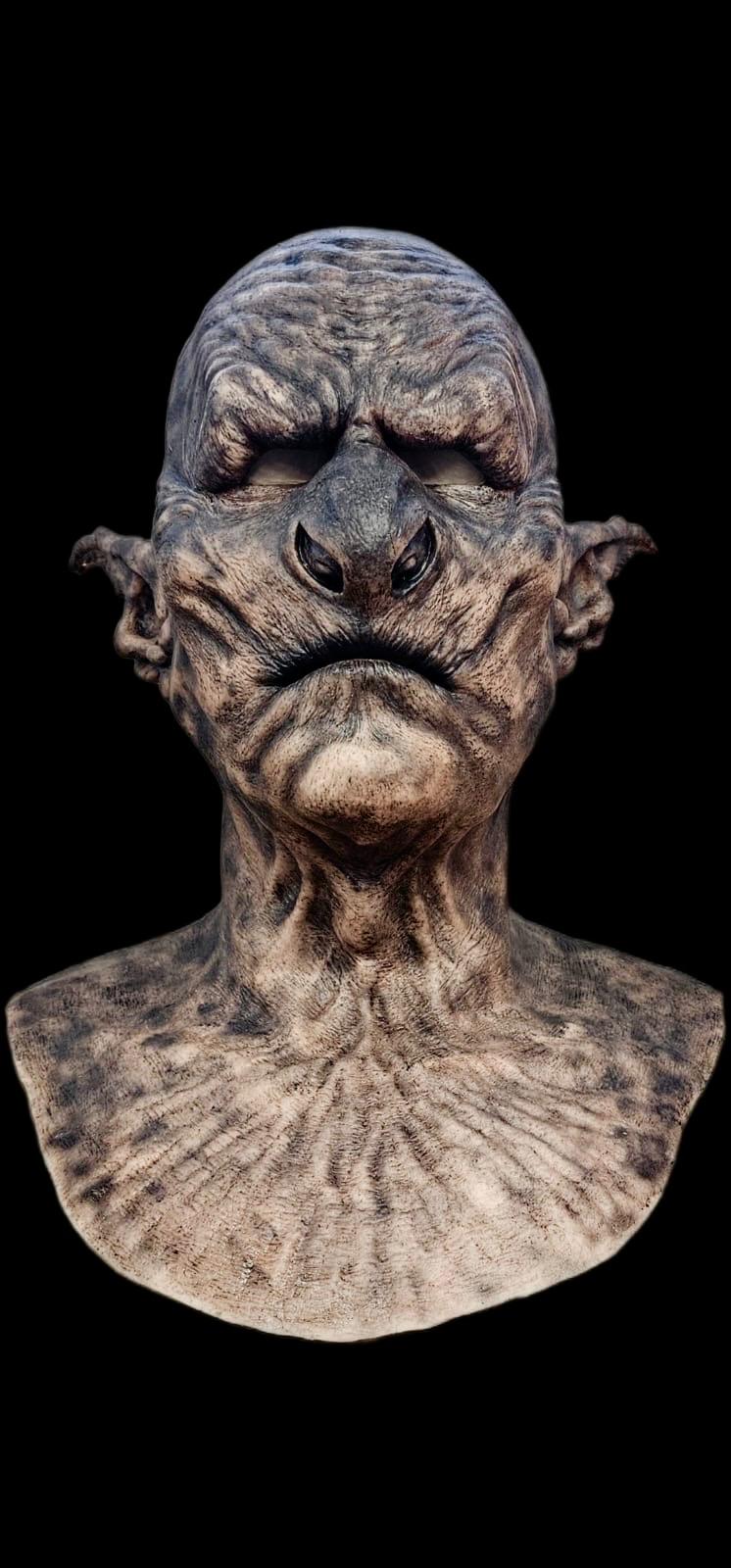 Terrifying orc mask with a dark background
