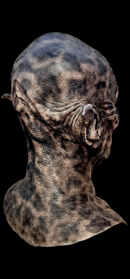 Bizarre Orc creature head mask with textured skin on a black background