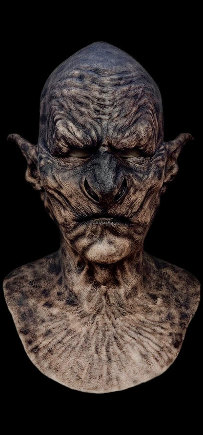 Detailed bust of a creature with a dark, textured surface on a black background