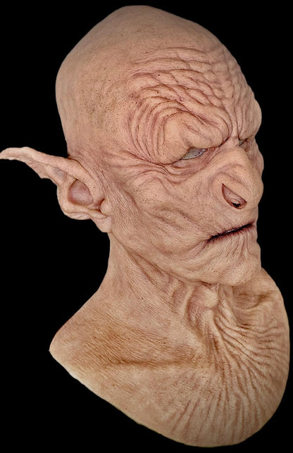 Close-up of a detailed alien mask with textured skin and pointed ears cosplay Goblin Orc