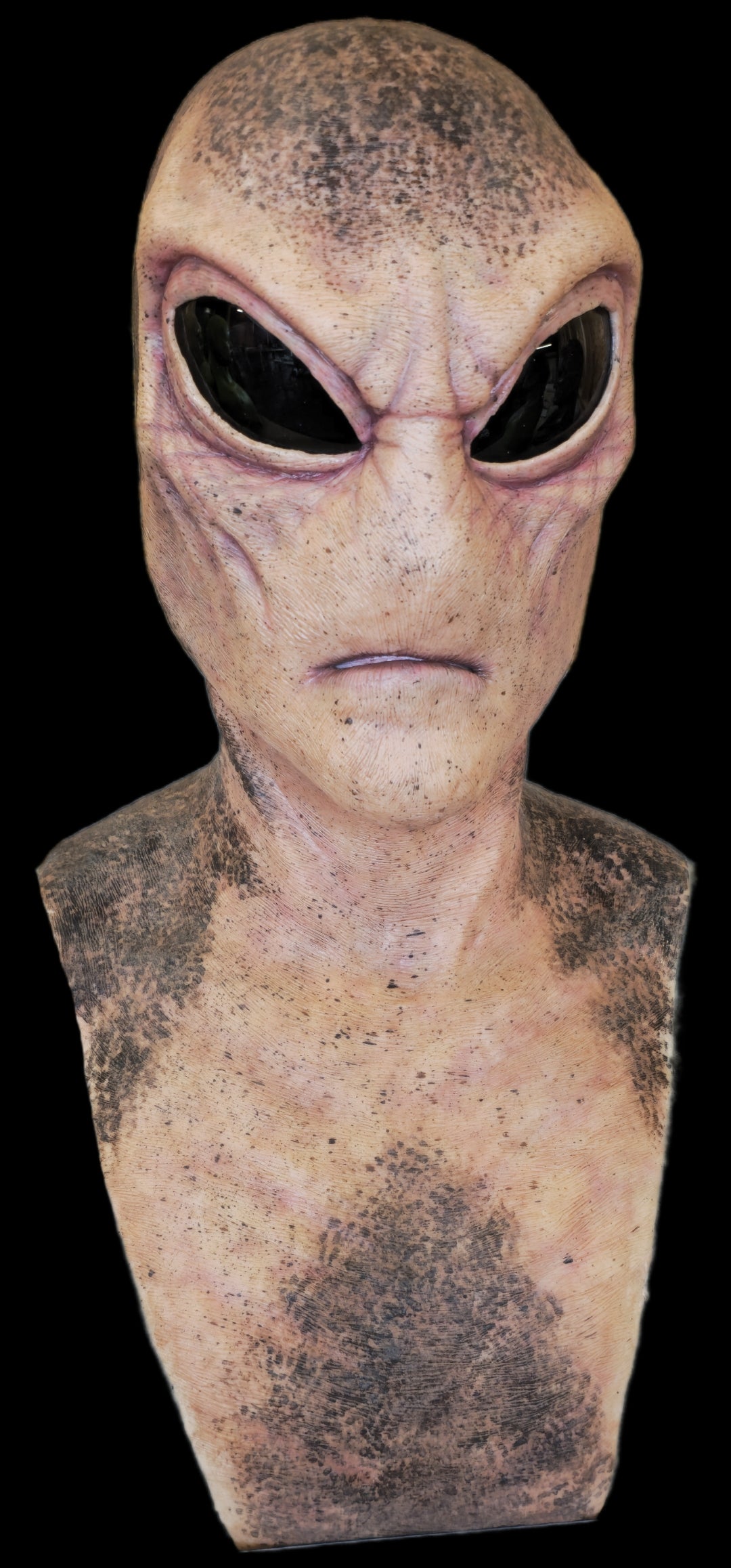 Alien head mask with a dark background
