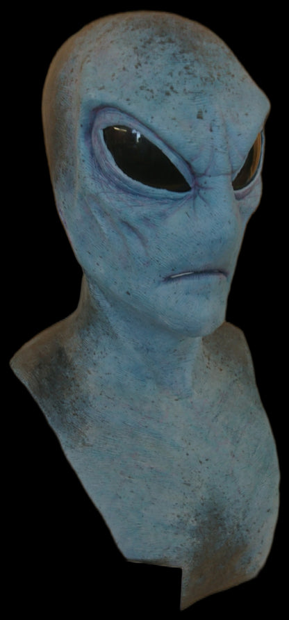 Blue alien mask with a serious expression and dark lenses