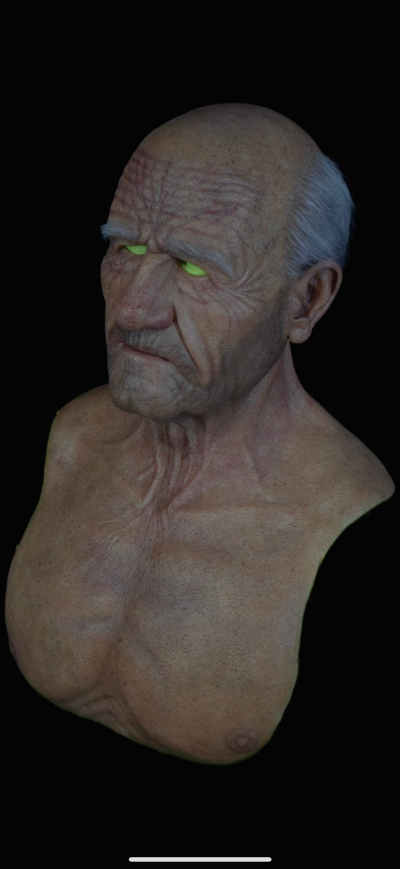 Mask of an elderly man with grey hair and a five o'clock shaddow