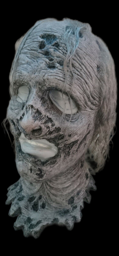 Detailed walking dead silicone mask with textured surface on a black background