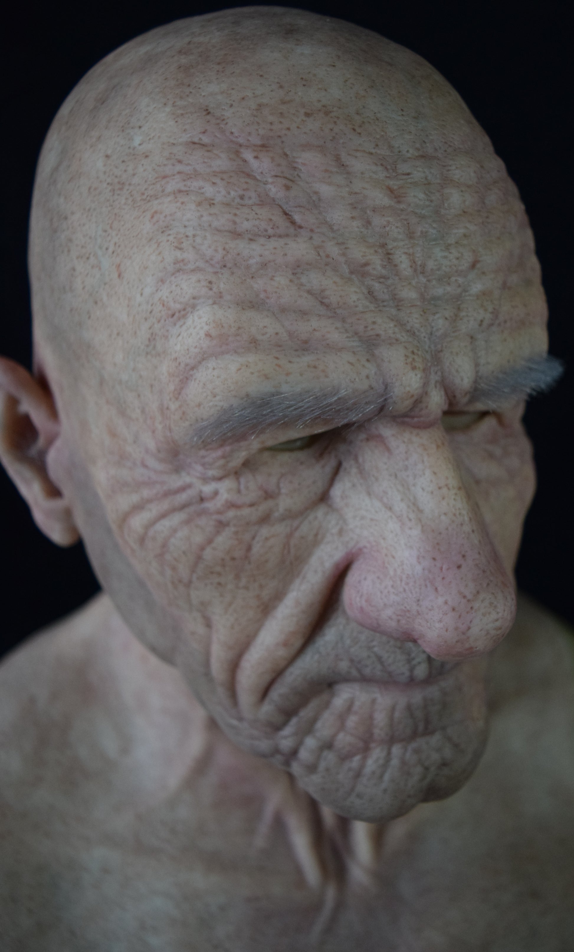 A close-up of a silicone mask with hand-punched eyebrows to enhance a costume's realistic appearance